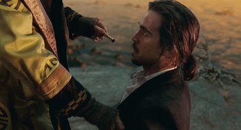 Movie still from “The Imaginarium of Doctor Parnassus” (2009), directed by Terry Gilliam – A man with long hair and a beard is holding a cigarette; Close Up shot, Over the shoulder angle