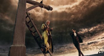 Movie still from “The Imaginarium of Doctor Parnassus” (2009), directed by Terry Gilliam – A man is hanging from a rope while another man watches; Wide shot, Low angle