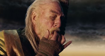 Movie still from “The Imaginarium of Doctor Parnassus” (2009), directed by Terry Gilliam – An old man with long white hair and a beard; Close Up shot, Low angle