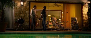 Movie still from “The Infiltrator” (2016), directed by Brad Furman – A group of people standing in front of an open window; Wide shot, Over the shoulder angle