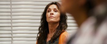 Movie still from “The Infiltrator” (2016), directed by Brad Furman – A person with long brown hair; Close Up shot, Over the shoulder angle