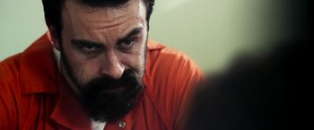 Movie still from “The Infiltrator” (2016), directed by Brad Furman – A person wearing an orange shirt; Close Up shot, Over the shoulder angle
