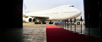 Movie still from “The Infiltrator” (2016), directed by Brad Furman – A large white airplane sitting on top of an airport runway; Extreme Wide shot, Low angle