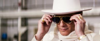 Movie still from “The Infiltrator” (2016), directed by Brad Furman – A man wearing a white hat and sunglasses; Extreme Close Up shot, Low angle