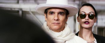 Movie still from “The Infiltrator” (2016), directed by Brad Furman – A person wearing a white hat; Close Up shot, Over the shoulder angle