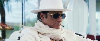 Movie still from “The Infiltrator” (2016), directed by Brad Furman – A man in a white hat and sunglasses smoking a cigarette; Close Up shot, Low angle