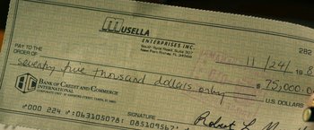 Movie still from “The Infiltrator” (2016), directed by Brad Furman – A check that is written on; Extreme Close Up shot, Overhead angle