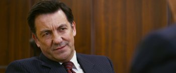 Movie still from “The Infiltrator” (2016), directed by Brad Furman – A person wearing a suit and tie; Close Up shot, Over the shoulder angle