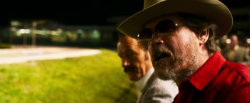 Movie still from “The Infiltrator” (2016), directed by Brad Furman – A man with a hat and a mustache and a man with a beard and glasses; Close Up shot, Low angle