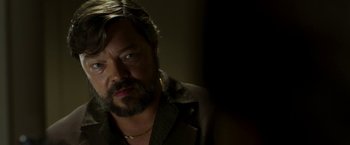 Movie still from “The Infiltrator” (2016), directed by Brad Furman – A person with a beard; Close Up shot, Over the shoulder angle