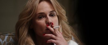 Movie still from “The Infiltrator” (2016), directed by Brad Furman – A woman smoking a cigarette while wearing red nail polish; Close Up shot, Low angle