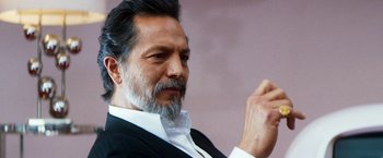 Movie still from “The Infiltrator” (2016), directed by Brad Furman – A person wearing a suit and beard; Close Up shot, Low angle