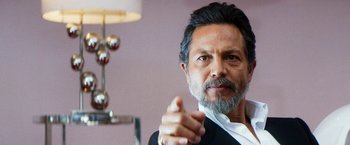 Movie still from “The Infiltrator” (2016), directed by Brad Furman – A person wearing a suit and beard; Close Up shot, Low angle