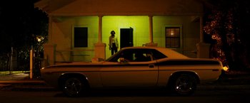 Movie still from “The Infiltrator” (2016), directed by Brad Furman – A man and a dog in the back seat of a car; Extreme Wide shot, Low angle