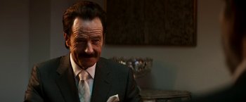 Movie still from “The Infiltrator” (2016), directed by Brad Furman – A person wearing a suit and tie; Close Up shot, Over the shoulder angle