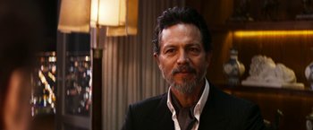 Movie still from “The Infiltrator” (2016), directed by Brad Furman – A person wearing a suit and tie; Close Up shot, Over the shoulder angle