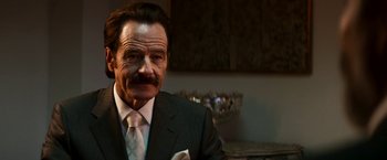 Movie still from “The Infiltrator” (2016), directed by Brad Furman – A person wearing a suit and tie; Close Up shot, Low angle