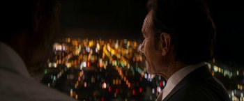 Movie still from “The Infiltrator” (2016), directed by Brad Furman – An older man looking out over a city at night; Close Up shot, Over the shoulder angle