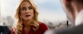 Movie still from “The Infiltrator” (2016), directed by Brad Furman – A woman with blonde hair wearing a red shirt; Close Up shot, Over the shoulder angle