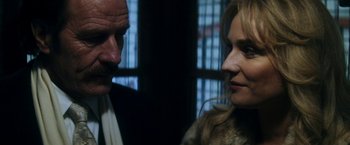 Movie still from “The Infiltrator” (2016), directed by Brad Furman – A man and a woman standing next to each other; Close Up shot, Over the shoulder angle