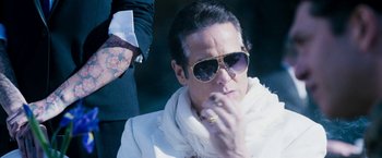 Movie still from “The Infiltrator” (2016), directed by Brad Furman – A man in sunglasses is smoking a cigarette; Close Up shot, Low angle
