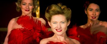 Movie still from “The Infiltrator” (2016), directed by Brad Furman – A person wearing a red dress; Close Up shot, Low angle