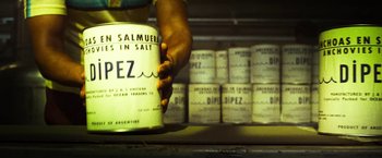 Movie still from “The Infiltrator” (2016), directed by Brad Furman – A person is holding a can in front of a shelf; Extreme Close Up shot, High angle