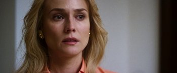 Movie still from “The Infiltrator” (2016), directed by Brad Furman – A woman's face in a white room; Close Up shot, Over the shoulder angle