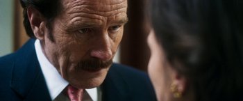 Movie still from “The Infiltrator” (2016), directed by Brad Furman – An older man with a mustache talking to a younger man; Close Up shot, Over the shoulder angle