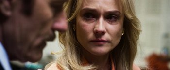 Movie still from “The Infiltrator” (2016), directed by Brad Furman – A woman's face as a man looks on; Close Up shot, Over the shoulder angle