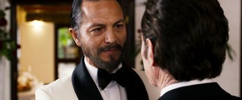 Movie still from “The Infiltrator” (2016), directed by Brad Furman – A person wearing a tuxedo looking at a mirror; Close Up shot, Over the shoulder angle