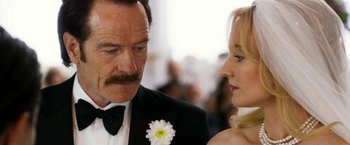 Movie still from “The Infiltrator” (2016), directed by Brad Furman – A man and a woman standing next to each other in formal wear; Close Up shot, Over the shoulder angle