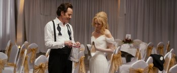 Movie still from “The Infiltrator” (2016), directed by Brad Furman – A man and a woman looking at a pair of shoes; Medium shot, Over the shoulder angle