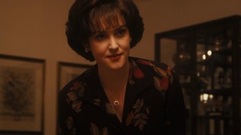 Movie still from “The Informant!” (2009), directed by Steven Soderbergh – A woman in a floral print shirt with a heart on her chest; Close Up shot, High angle