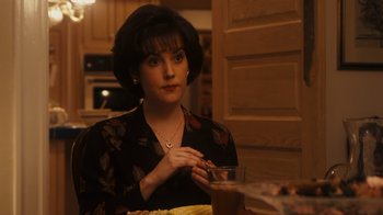 Movie still from “The Informant!” (2009), directed by Steven Soderbergh – A woman sitting at a table with a glass of wine; Close Up shot, High angle