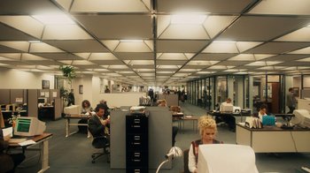 Movie still from “The Informant!” (2009), directed by Steven Soderbergh – A group of people in an office setting; Extreme Wide shot, High angle