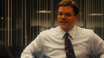 Movie still from “The Informant!” (2009), directed by Steven Soderbergh – A person wearing glasses and a tie; Close Up shot, Over the shoulder angle