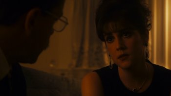 Movie still from “The Informant!” (2009), directed by Steven Soderbergh – A woman sitting in front of a man in a dark room; Close Up shot, Over the shoulder angle