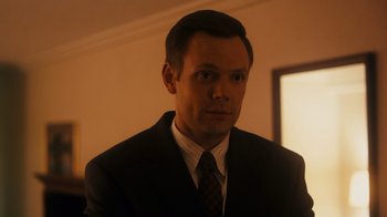 Movie still from “The Informant!” (2009), directed by Steven Soderbergh – A person wearing a suit and tie; Close Up shot, Over the shoulder angle