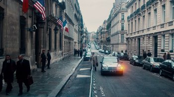 Movie still from “The Informant!” (2009), directed by Steven Soderbergh – Cars parked on the side of the road in a city; Extreme Wide shot, High angle