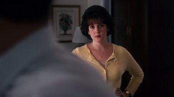 Movie still from “The Informant!” (2009), directed by Steven Soderbergh – A woman in a yellow sweater looking at a man in a black hat; Close Up shot, Over the shoulder angle