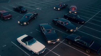 Movie still from “The Informant!” (2009), directed by Steven Soderbergh – A bunch of cars parked in a parking lot; Extreme Wide shot, High angle