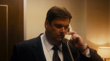 Movie still from “The Informant!” (2009), directed by Steven Soderbergh – A person talking on a phone; Close Up shot, High angle