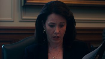 Movie still from “The Informant!” (2009), directed by Steven Soderbergh – A person sitting in a chair wearing a suit; Close Up shot, High angle