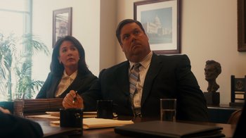 Movie still from “The Informant!” (2009), directed by Steven Soderbergh – A man and a woman sitting in front of a table; Medium shot, Over the shoulder angle
