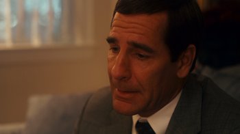 Movie still from “The Informant!” (2009), directed by Steven Soderbergh – A person wearing a suit and tie; Close Up shot, Over the shoulder angle