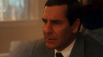 Movie still from “The Informant!” (2009), directed by Steven Soderbergh – A person wearing a suit and tie; Close Up shot, Over the shoulder angle