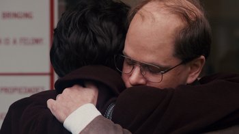 Movie still from “The Informant!” (2009), directed by Steven Soderbergh – A man hugging another man with glasses on; Close Up shot, Over the shoulder angle