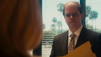 Movie still from “The Informant!” (2009), directed by Steven Soderbergh – A man in a suit and tie looking at a woman in a dress shirt; Close Up shot, Over the shoulder angle