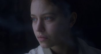 Movie still from “The Innocents” (2016), directed by Anne Fontaine – A person with blue eyes; Close Up shot, Over the shoulder angle